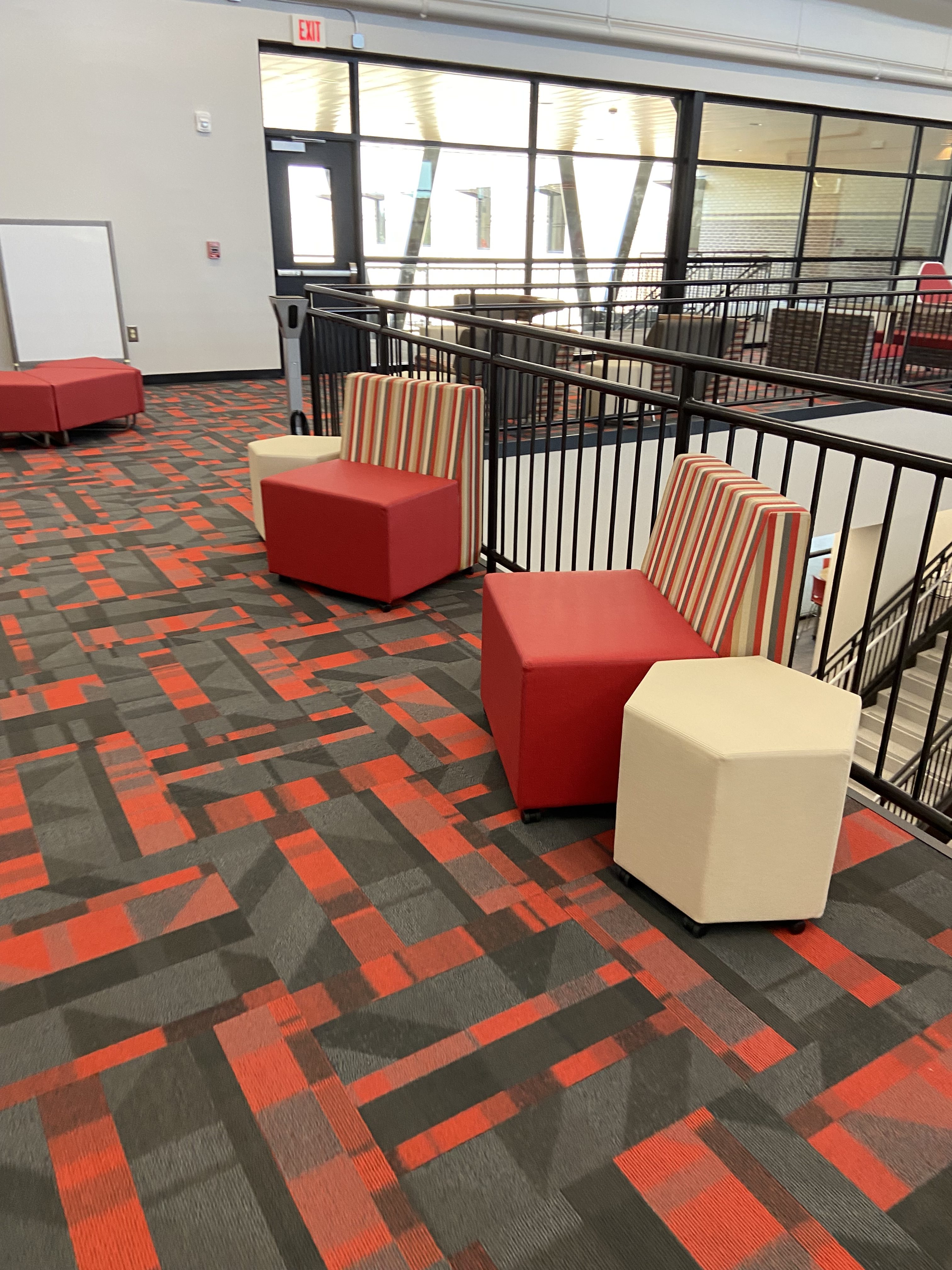 red chairs and octagonal tables against black railing