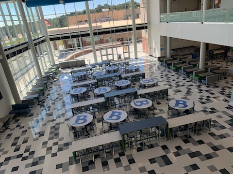 looking down over large open space with branded tables and chairs