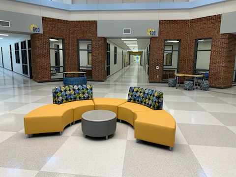 half circle couch surrounding small round table