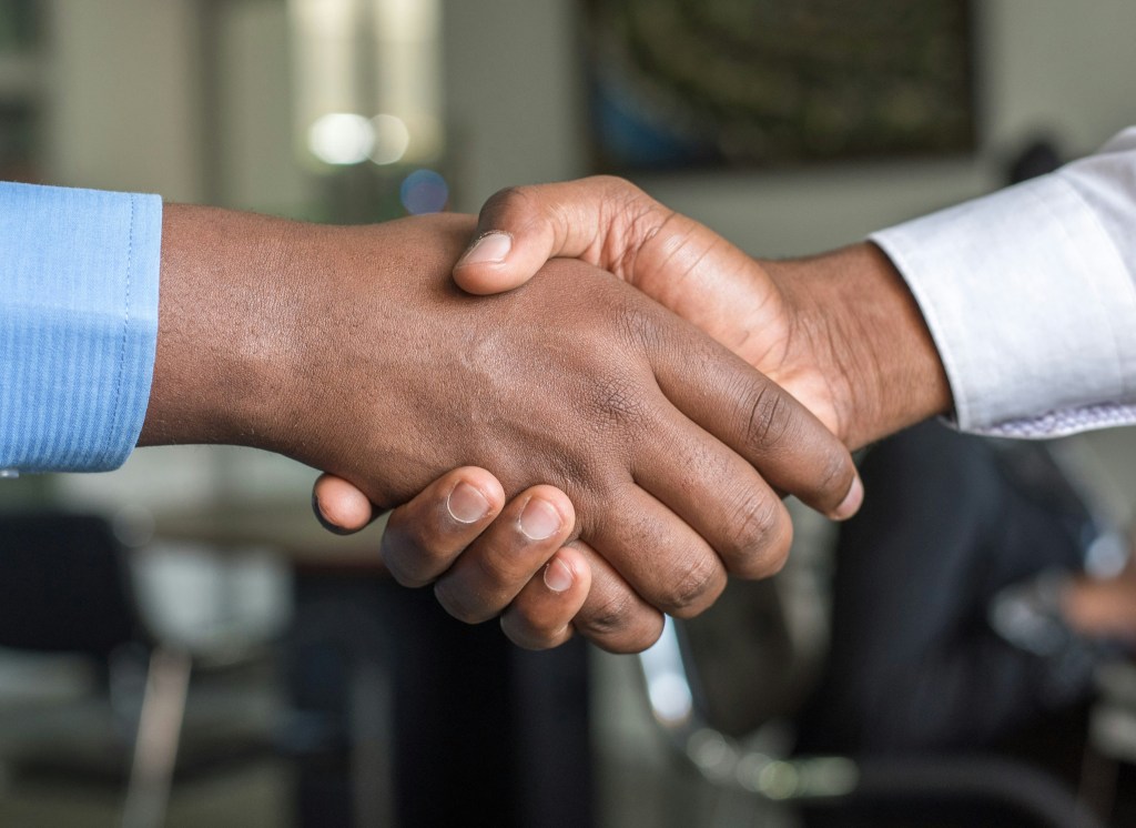 a close up of shaking hands